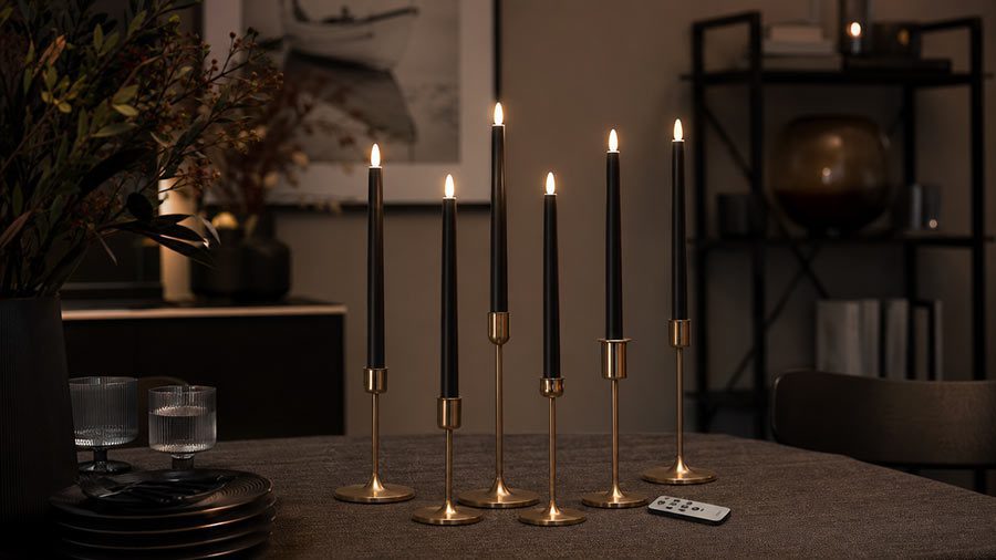 black flameless taper candles with remote on modern dining table